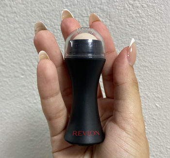 A reviewer holding the face roller