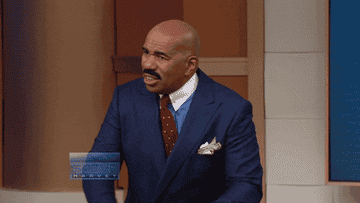 Steve Harvey spitting something out.