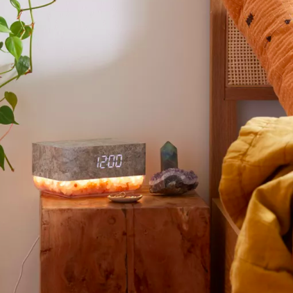 A glowing alarm clock with a himalayan salt base