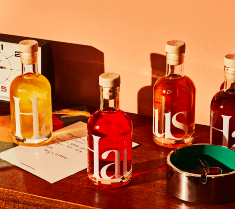 Four bottles of Haus liquor on a table