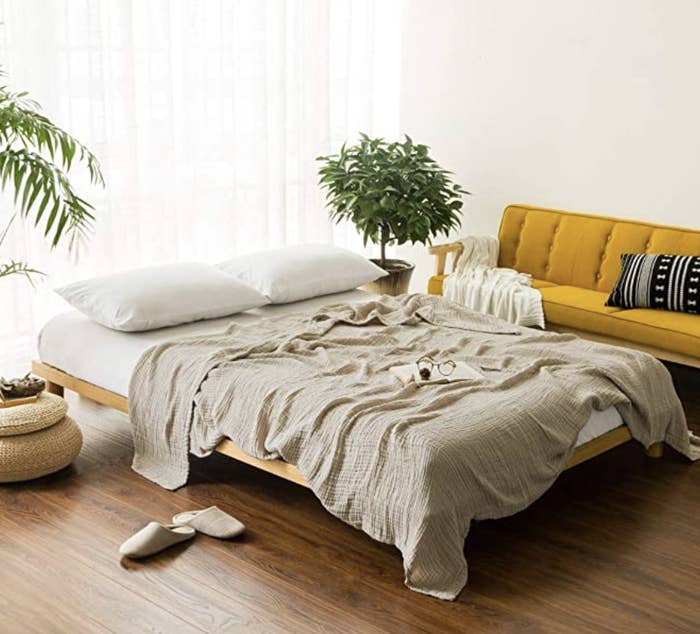 muslin throw blanket on top of bed
