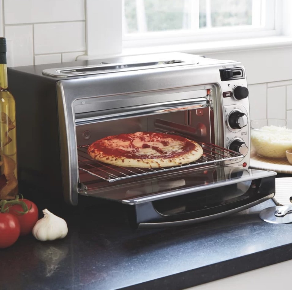 A Hamilton Beach toaster oven with a pizza inside