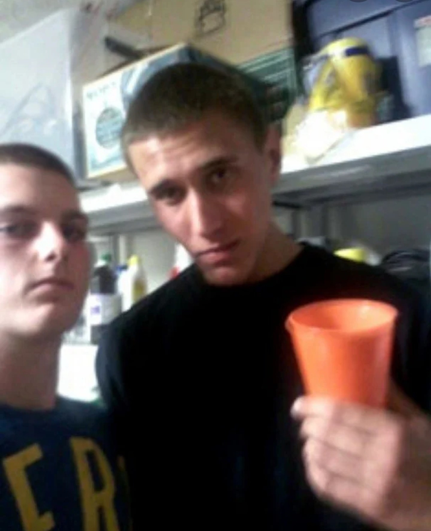 Tyler Hadley holding a cup and posing with his best friend Michael Mandell