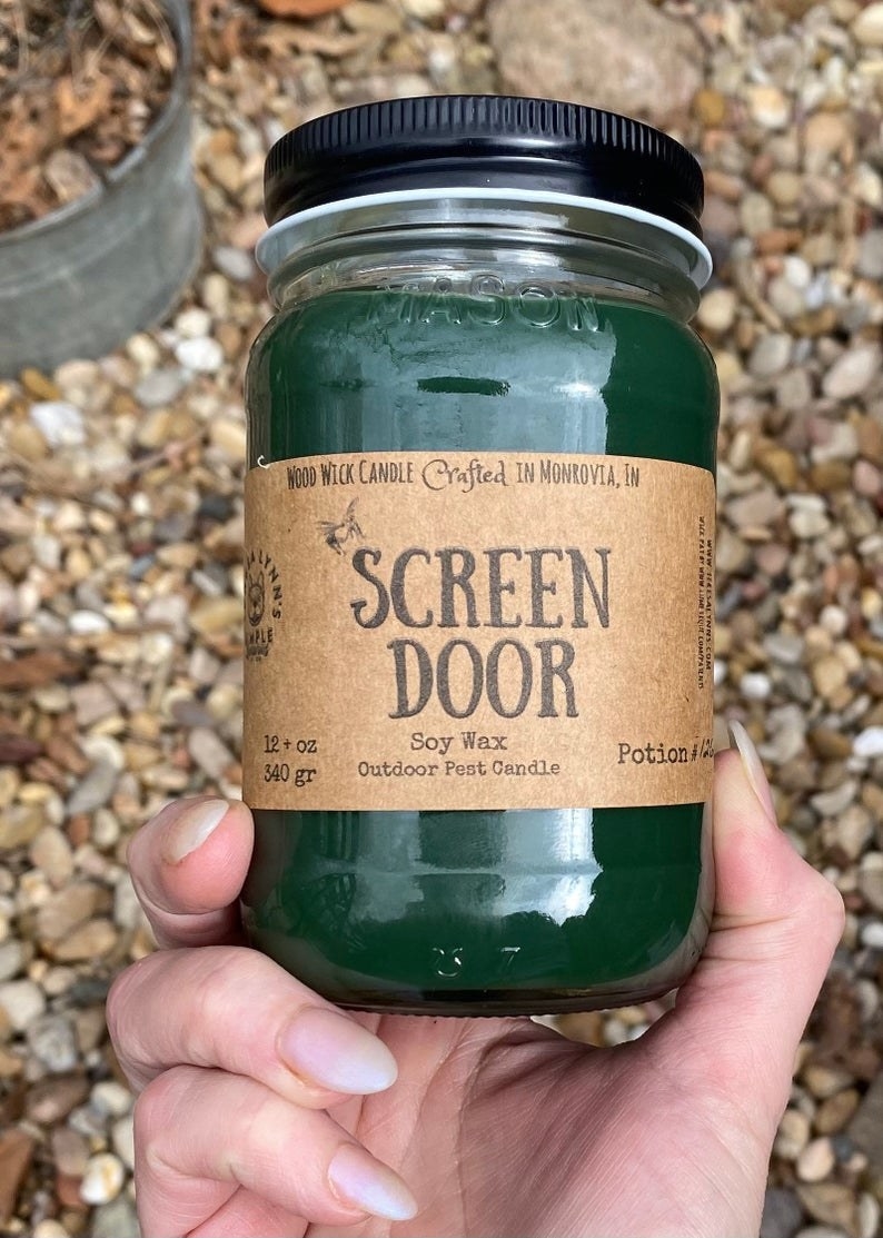 the screen door candle in a model&#x27;s hand