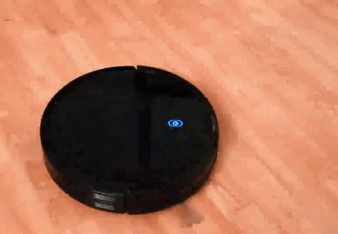 GIF of reviewer's robo vac moving across a wooden floor