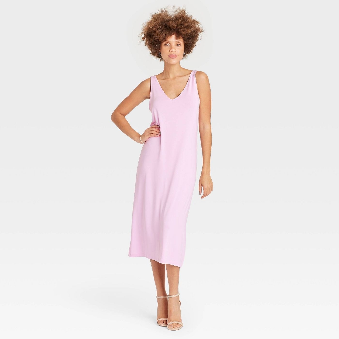 A model wearing a light pink sleeveless knit dress