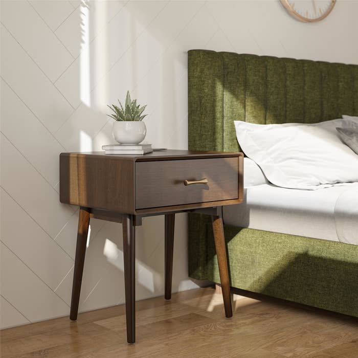 Brown one-drawer nightstand in trendy bedroom