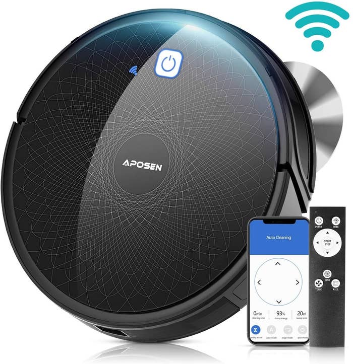 Black, circle robot vacuum cleaner and remote control