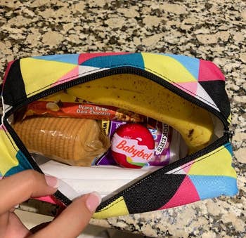 Reviewer's photo showing the box in triangle stripes print filled with snacks