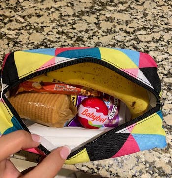 Reviewer's photo showing the box in triangle stripes print filled with snacks