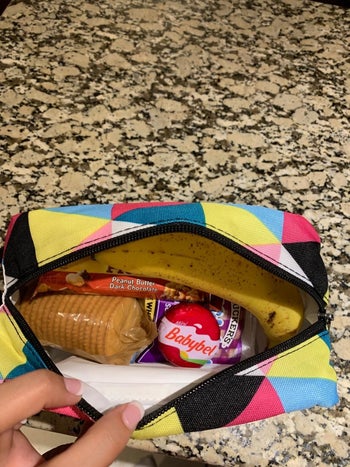 Reviewer's photo showing the box in triangle stripes print filled with snacks