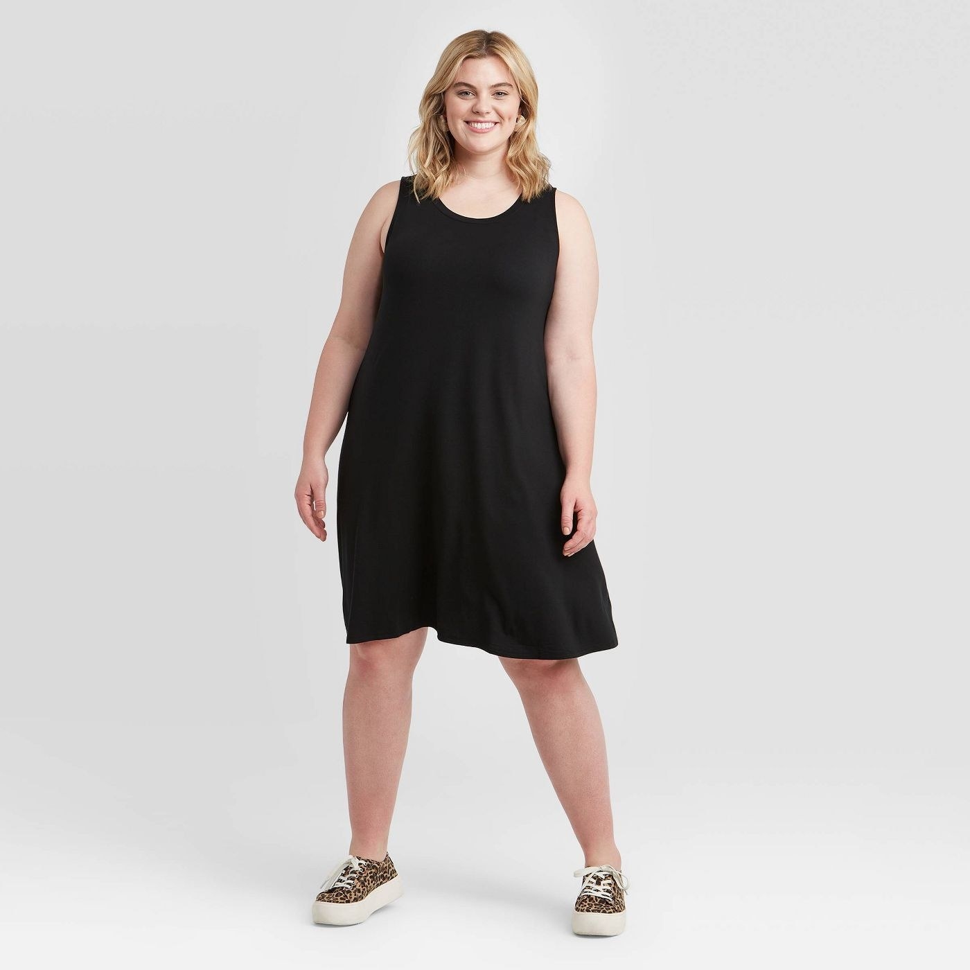 A model wearing a black tank swing dress