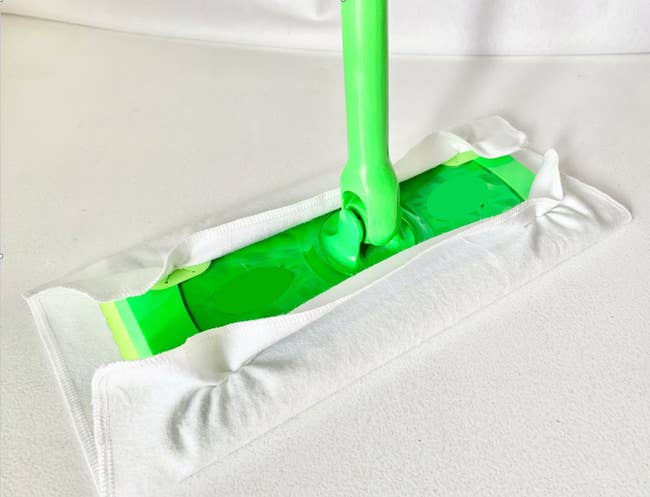 White cotton cover wrapped around a green Swiffer