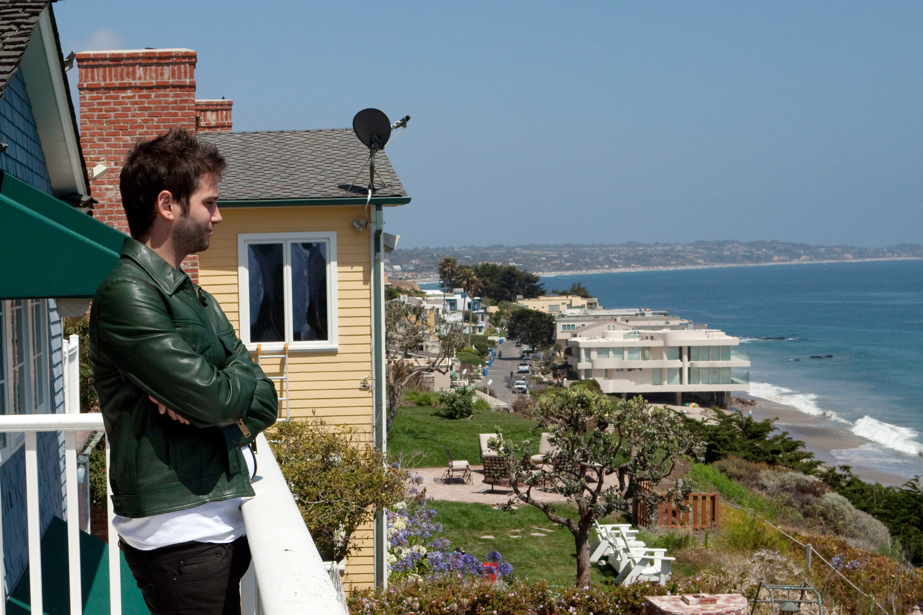 Josh Flagg looks over the ocean from a balcony