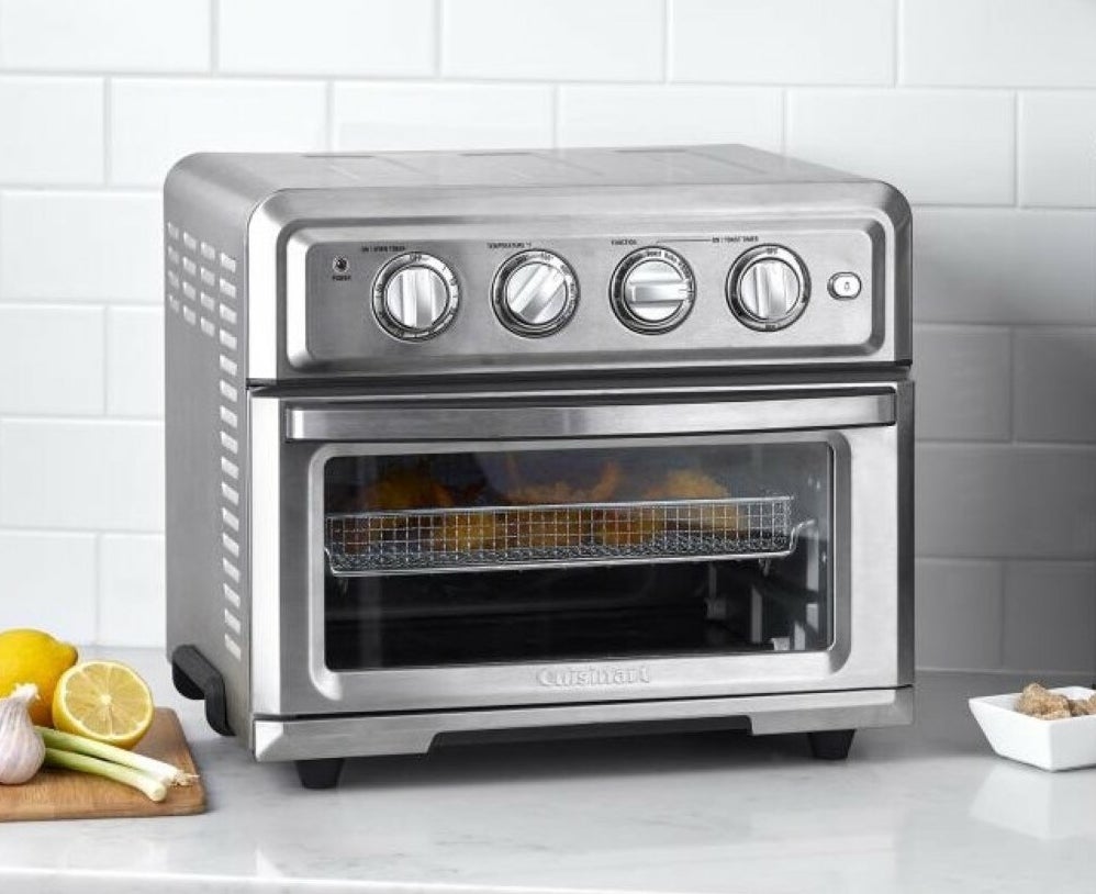 Stainless steel Cuisinart air fryer toaster oven with chicken inside
