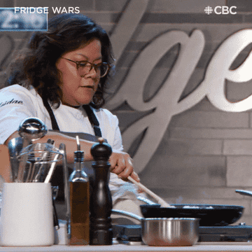 a chef flipping rice in a pan