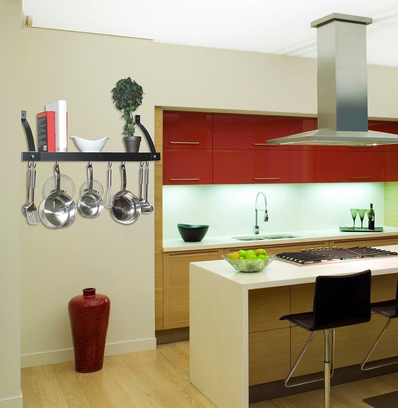 a staged kitchen with a pot rack/bookshelf hanging on the wall