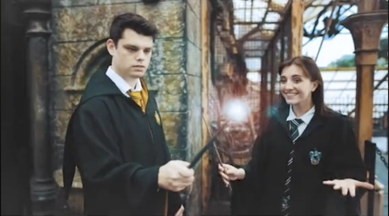 The couple holding their wands