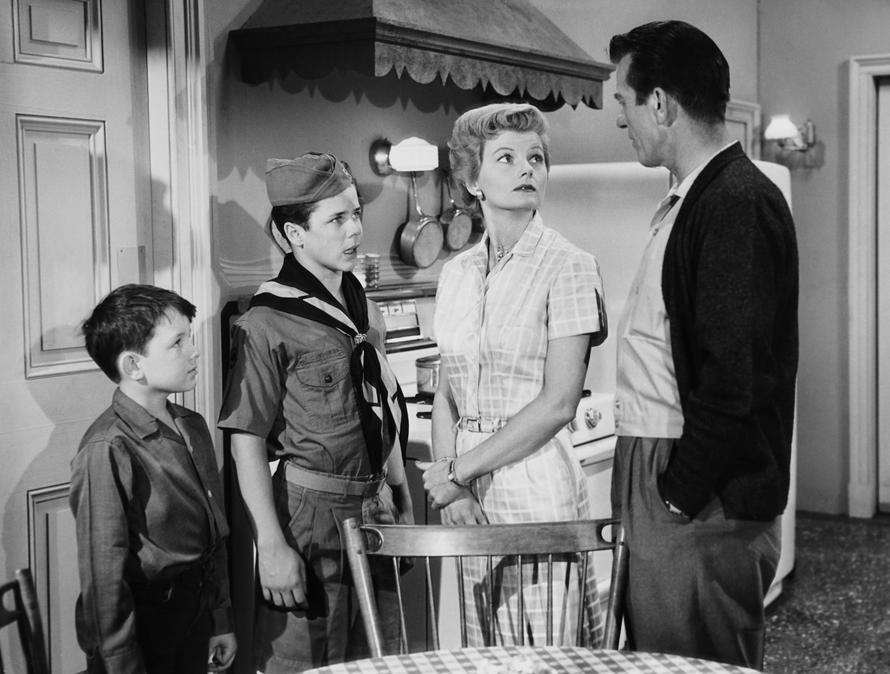 Jerry Mathers, Tony Dow, Barbara Billingsley, and Hugh Beaumont stand in the kitchen