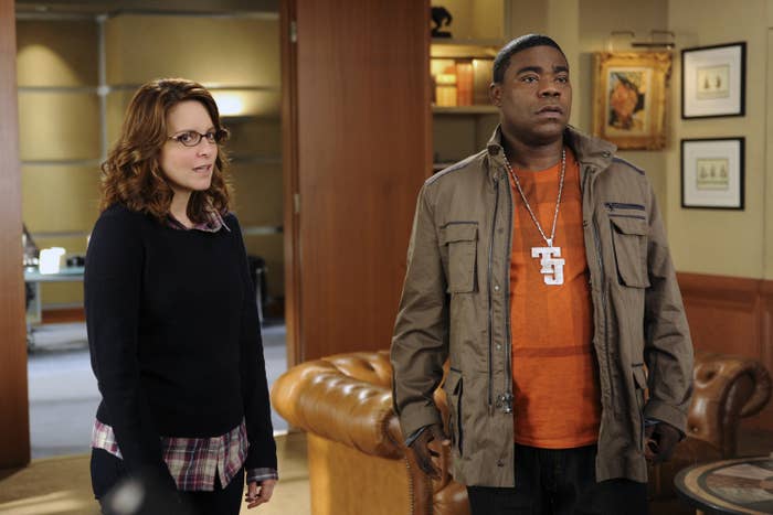 Tina Fey and Tracy Morgan stand in an office