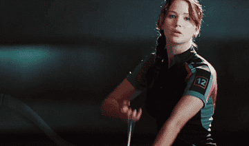 Katniss Everdeen draws her bow and arrow