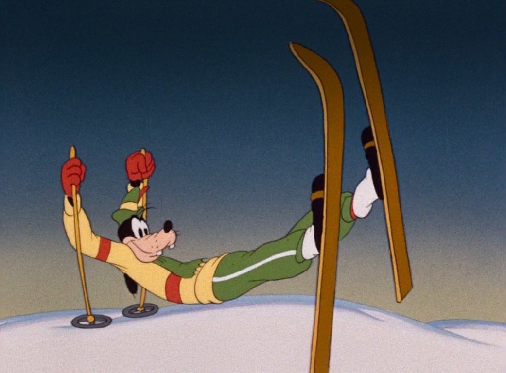 Goofy holds himself up with his skis and poles