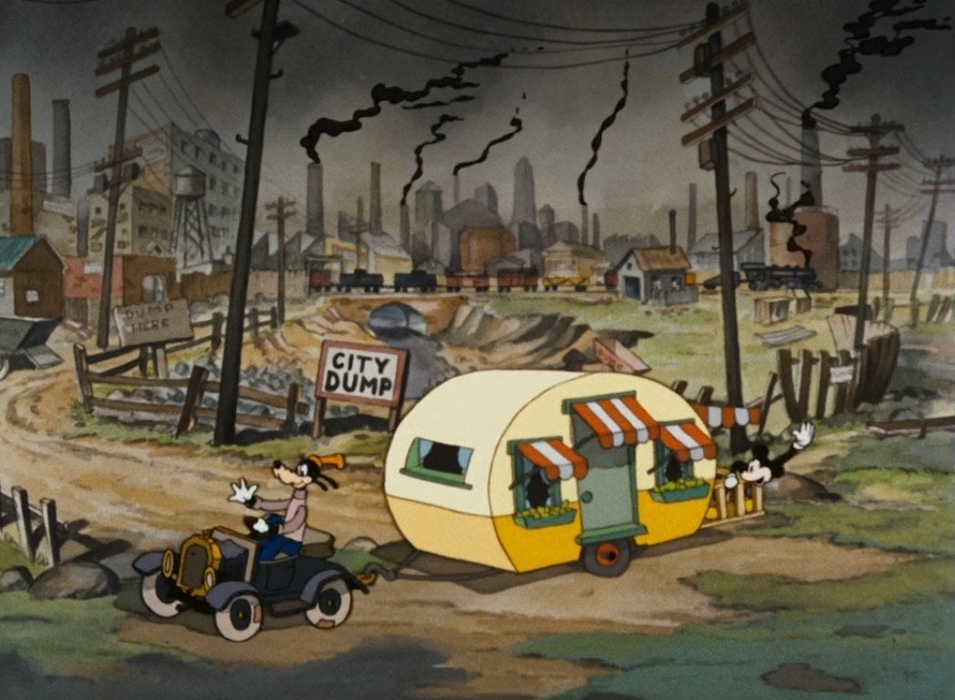 Goofy drives Mickey&#x27;s trailer away from the city dump