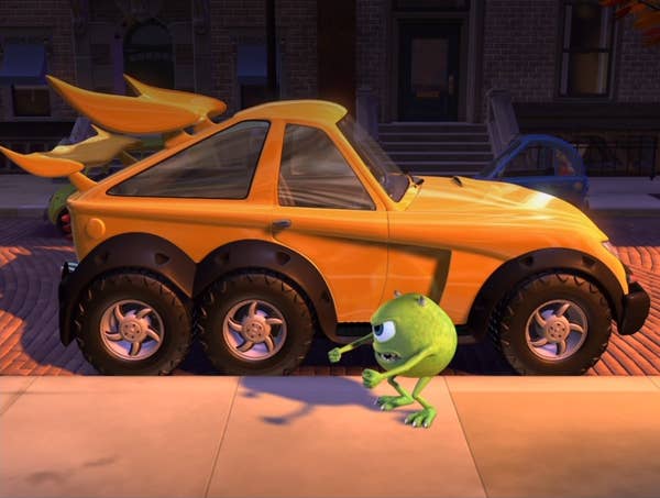 Mike Wazowski stands outside a brand new car