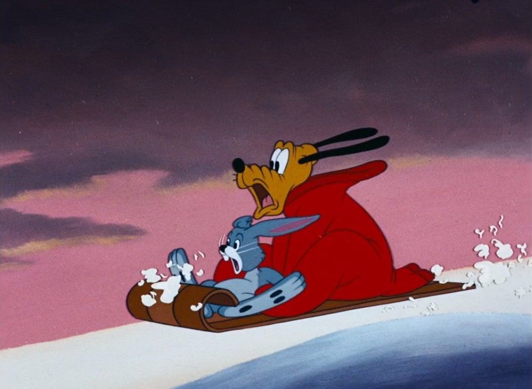 Pluto and a rabbit on a sled