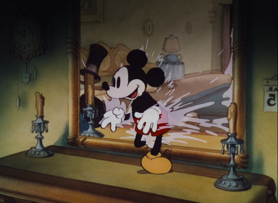 Mickey Mouse walking through a mirror