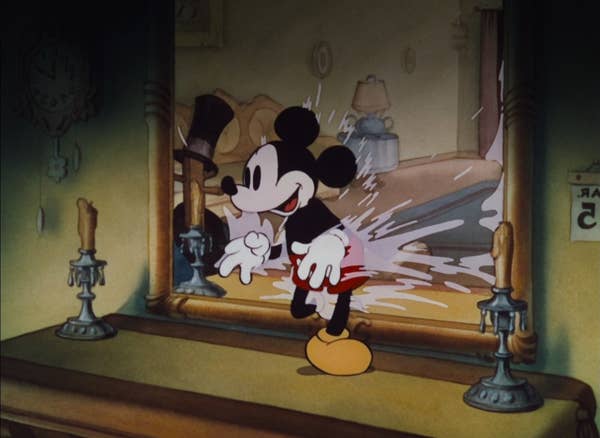 Mickey Mouse walking through a mirror