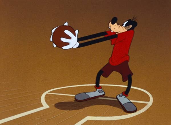 Goofy holds a basketball on the free throw line