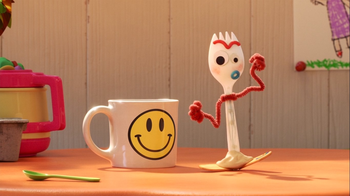 Forky stands next to a smiley face mug
