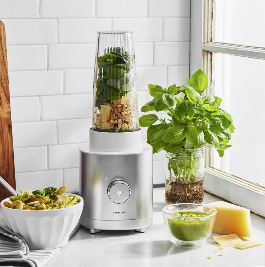 Silver personal blender with fruit, nuts and spinach inside