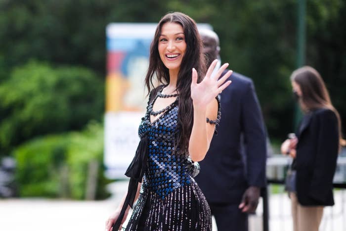 Bella Hadid wears a black and blue shiny sequined dress with fringes, outside Louis Vuitton Parfum hosts dinner at Fondation Louis Vuitton, during Paris Fashion Week - Haute Couture Fall/Winter 2021/2022, on July 05, 2021 in Paris, France