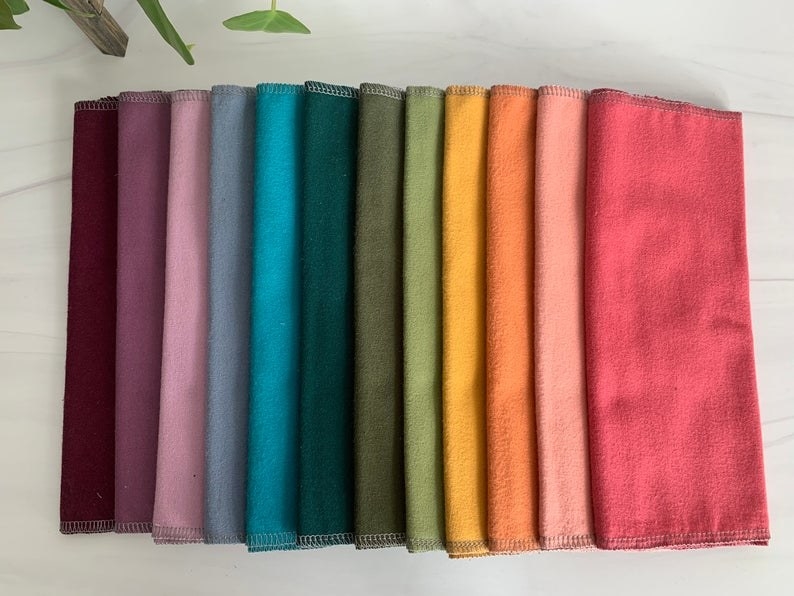 Various towels of different color on table