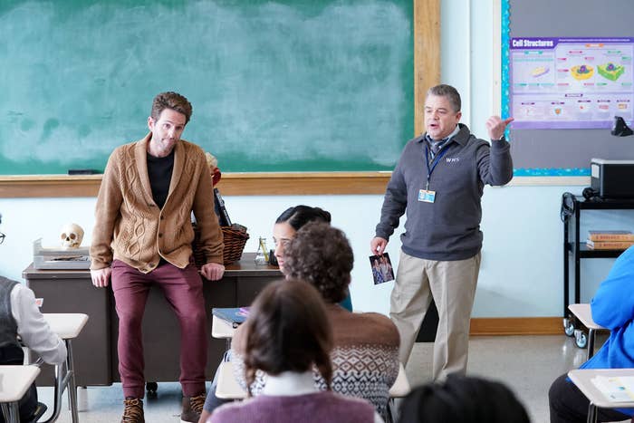 Glenn Howerton and Patton Oswalt stand in front of a class