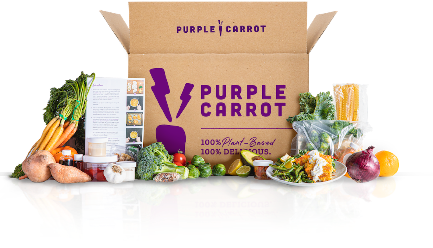 the purple carrot box surrounded by vegetables and a recipe card
