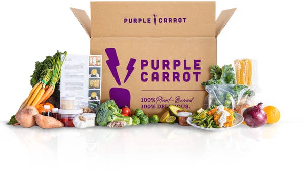 the purple carrot box surrounded by vegetables and a recipe card
