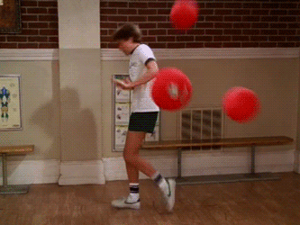 A man getting hit with several dodgeballs