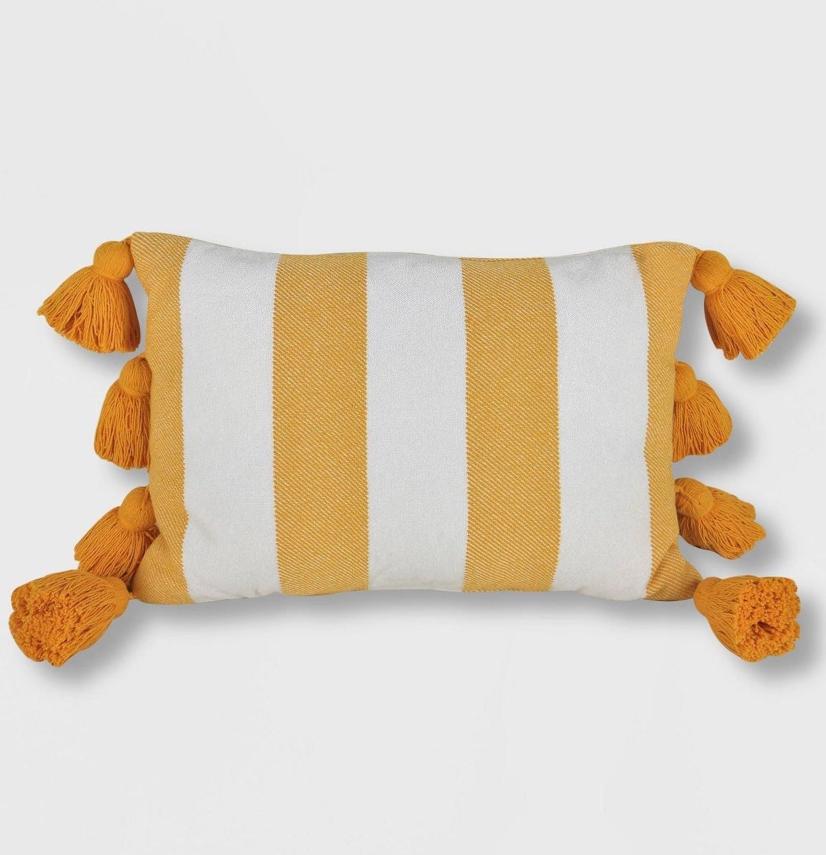 yellow and white stripe throw pillow with large tassels