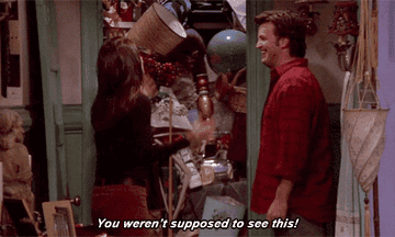 Gif of the character Monica from &quot;Friends&quot; in front of junk closet saying &quot;You weren&#x27;t supposed to see this!&quot; to the character Chandler
