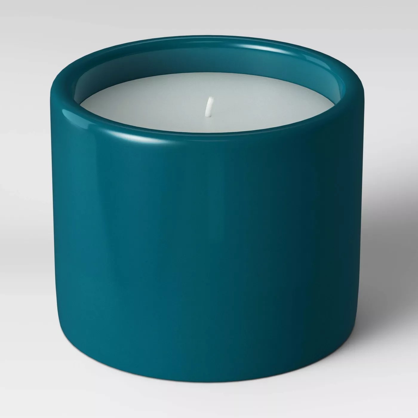The candle in a green ceramic holder
