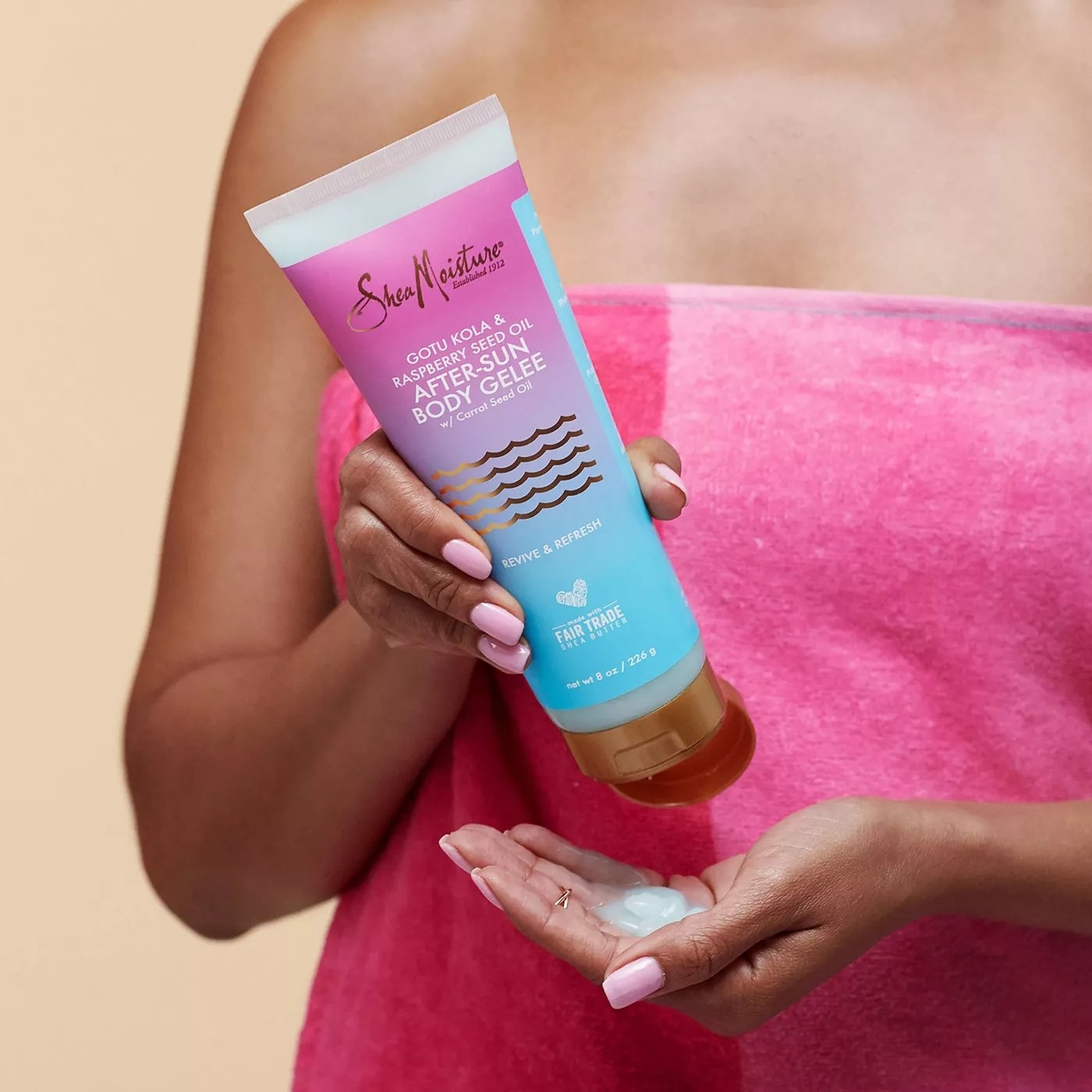 A model holding a tube of the after sun treatment