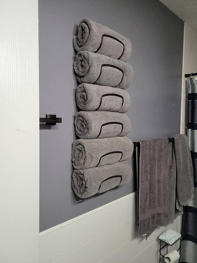 reviewer's towel rack holding six grey towels