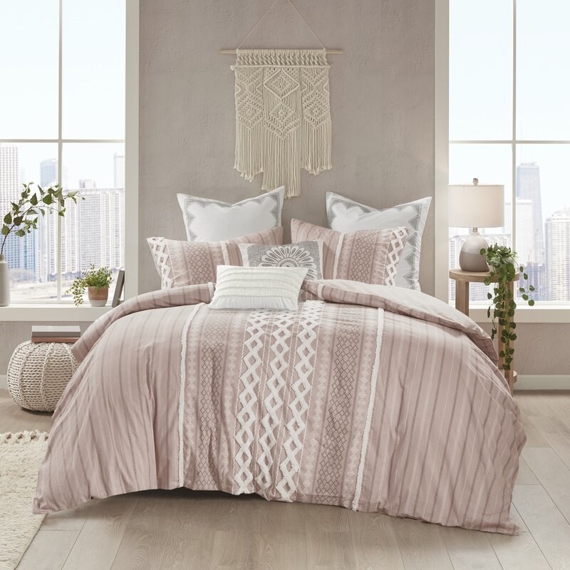 the duvet set in pink on a bed