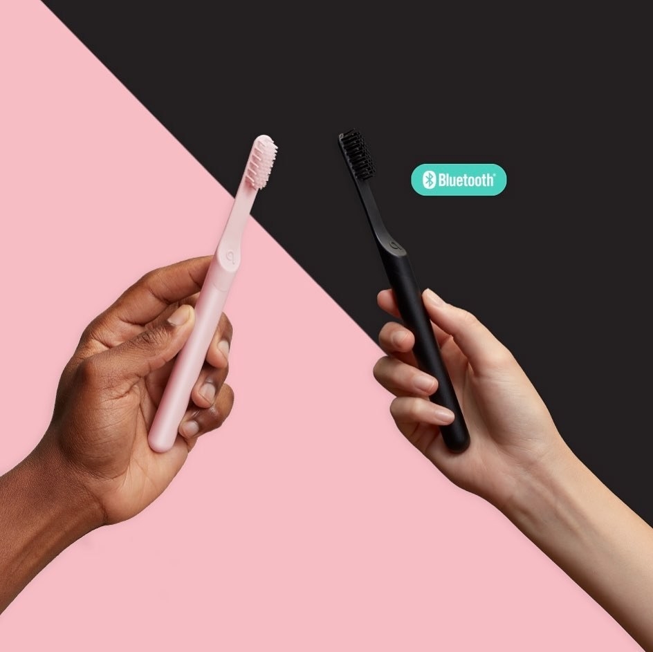 pink and black toothbrushes