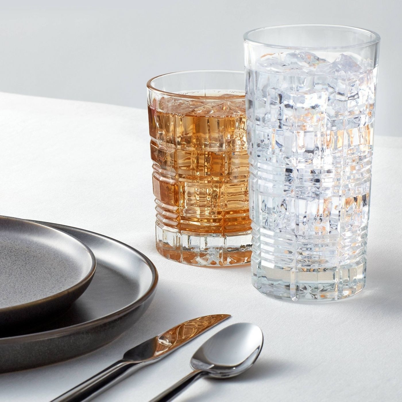 two different sizes of beveled drinking glasses
