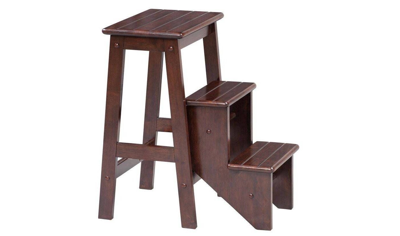 a dark wooden step stool with three steps