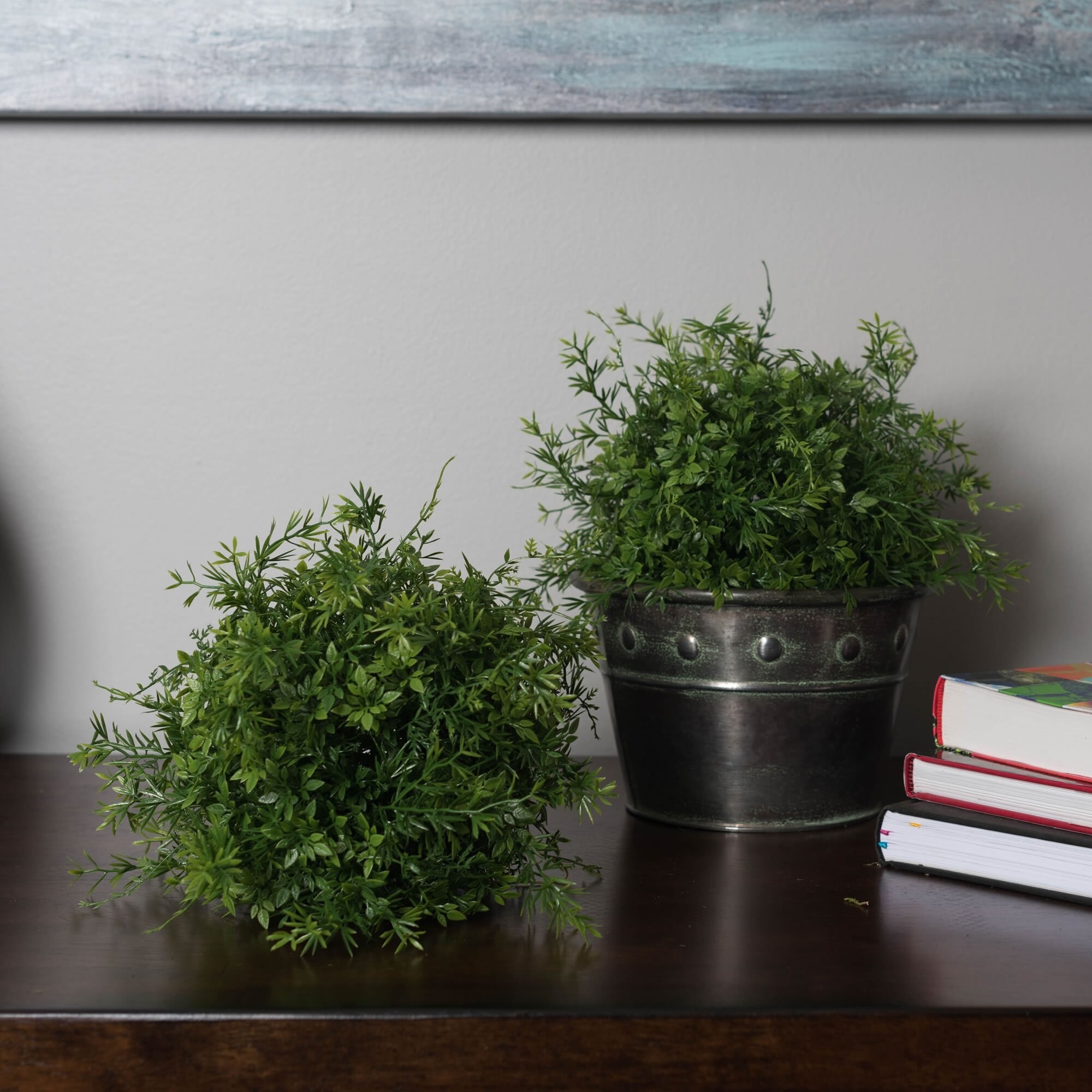 Faux plants on console table